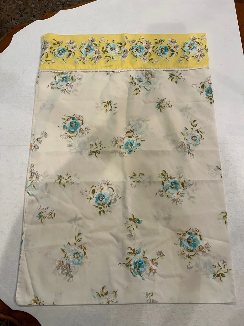 Vintage Montgomery Ward cream floral pillow case with yellow edge accent.